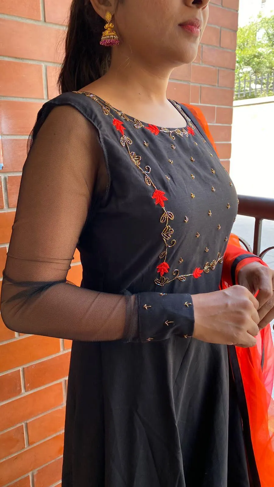 Black rose silk salwar suit of hand worked top and a red Duppata